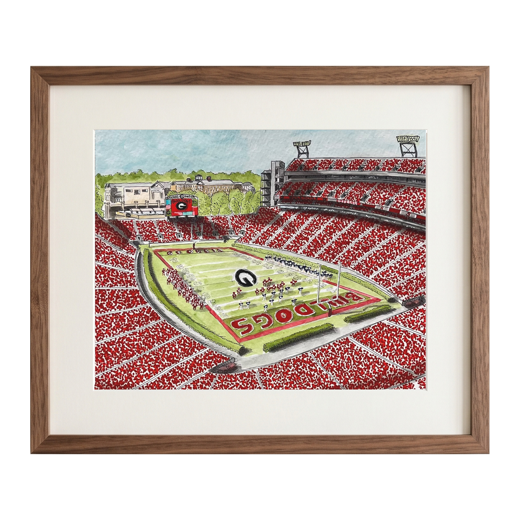 A framed hand-drawn illustration of a football stadium filled with red spectators, featuring a green field and the word 'BULLETS' on the turf, shown in a brown wood frame with a white mat.